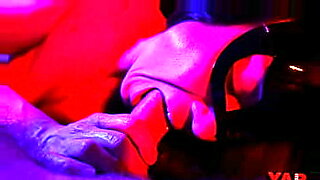 A masked woman sucks a big cock with an ending in her mouth a gentle blowjob in neon light to the music