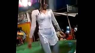 Hot Indian woman dances in the rain and gets wet.