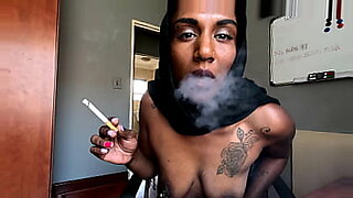 Amateur hijabi in fishnet and clamps, smoking while being teased.