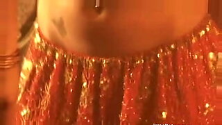 Hot Asian woman dances and strips for pleasure.